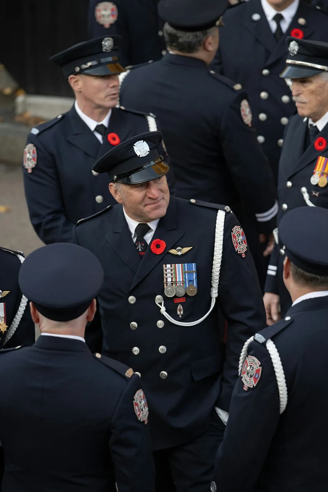 Three honor-guard soldiers marching in ceremonial uniform with bullion sword knots